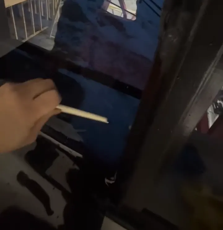 Window film being squeegeed onto a building window