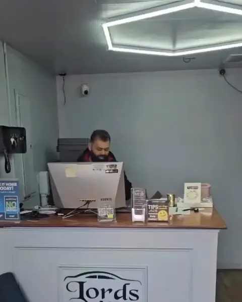The front desk at Lords Detailing under the hexagon light