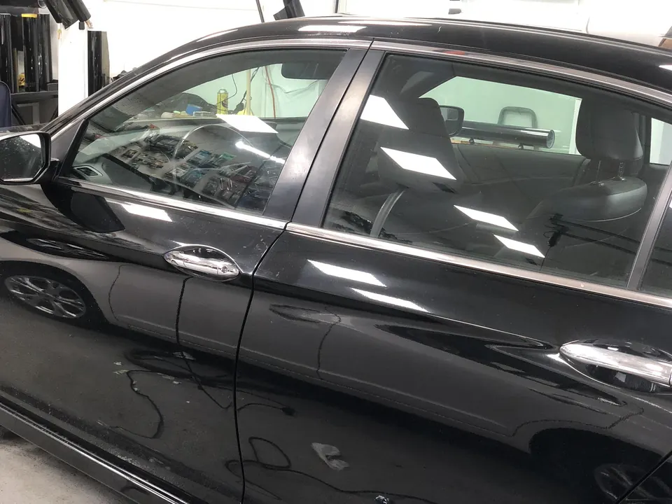 Black sedan with freshly tinted side windows